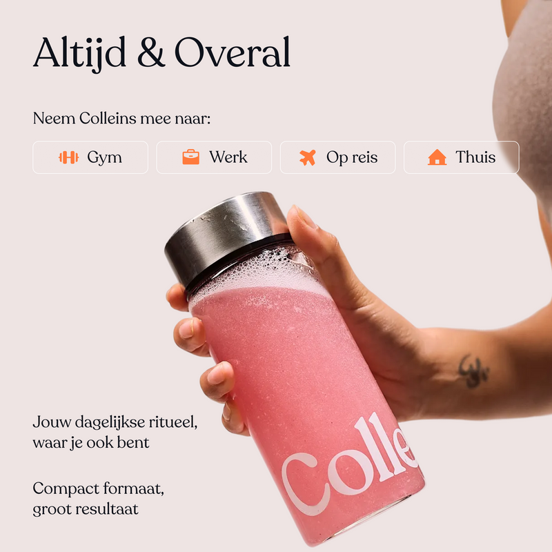 Pink Lemonade from Colleins by Mijn winkel in a clear glass with fresh lemon slices and ice cubes.